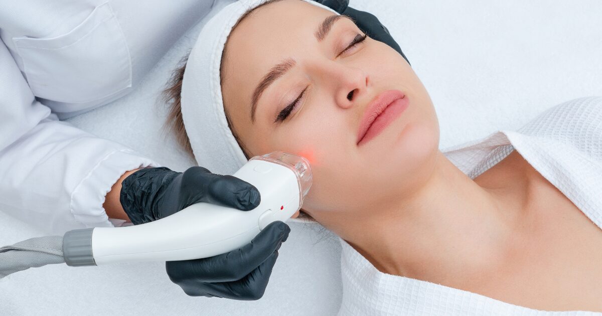 A woman receiving MOXI skin treatment at clinic