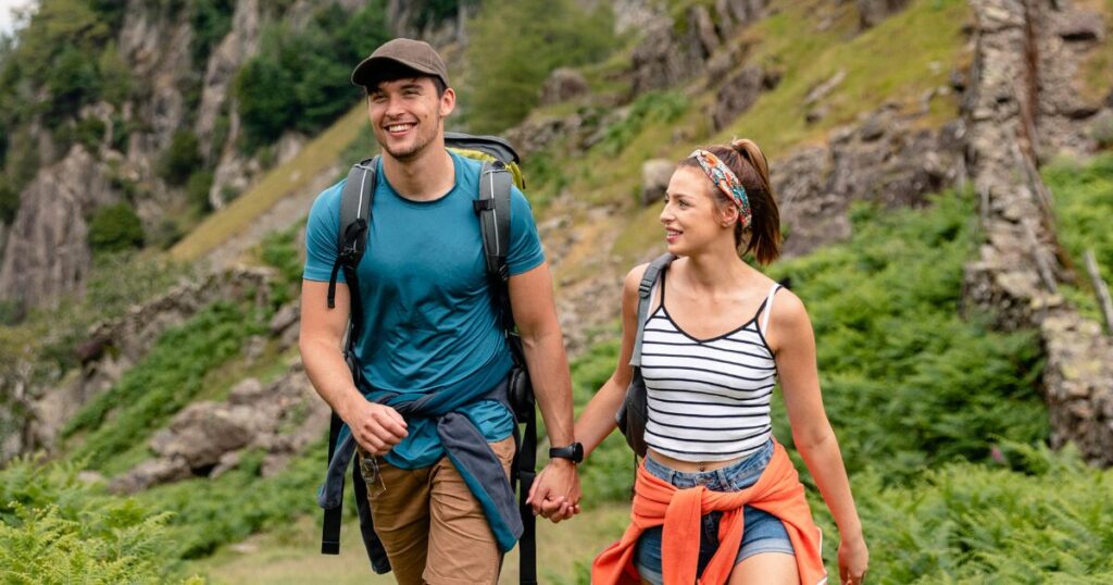 A Man and Woman Rucking for Weight Loss With a Backpack 